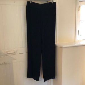 Black pleated dress pants with wide waste band and pretty flowing leg. Lined